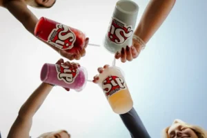 customer ordering a customized dirty soda drink with syrups and cream at a soda café counter